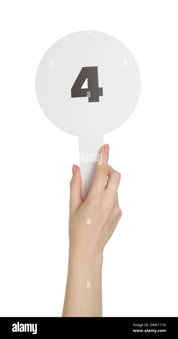 Woman holding auction paddle with number 4 on white background, closeup Stock Photo