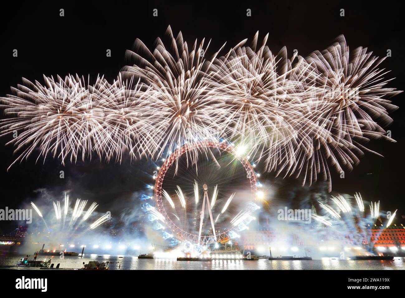 Fireworks light up the sky over the London Eye in central London during