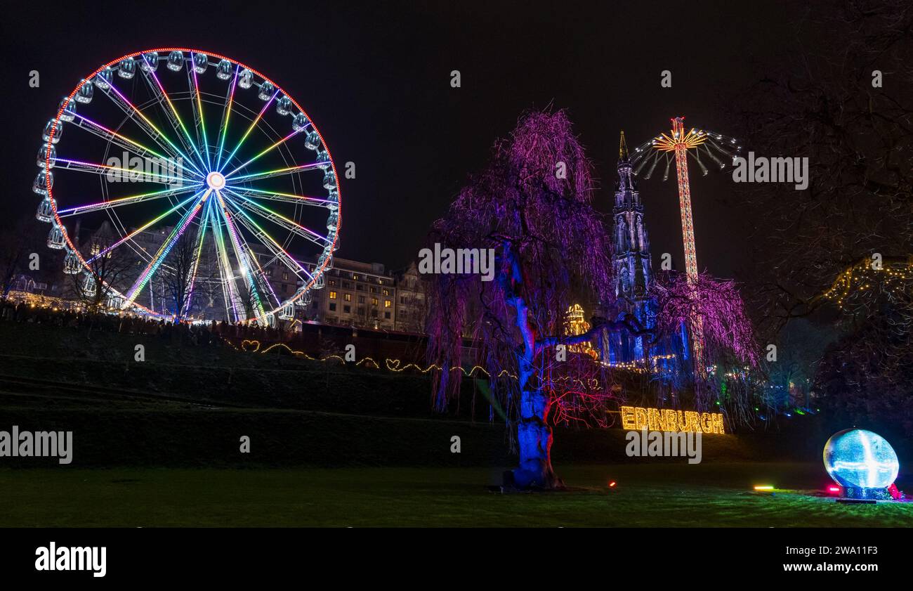 Edinburgh, Scotland, UK, 31st December 2023. Hogmanay New year celebrations: the fairground rides in Princes Street Gardens next to the Sir Walter Scott monument are a major attraction as midnight approaches. Credit: Sally Anderson/Alamy Live News Stock Photo