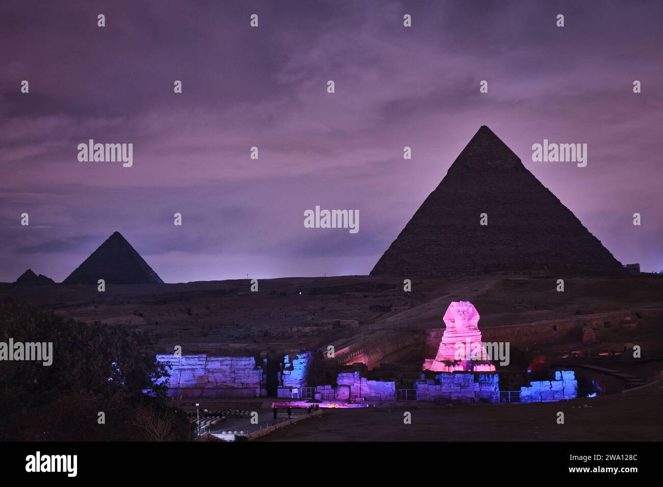 Giza, Egypt - December 24 2023: The Pyramids and the Sphinx in the night lights Stock Photo