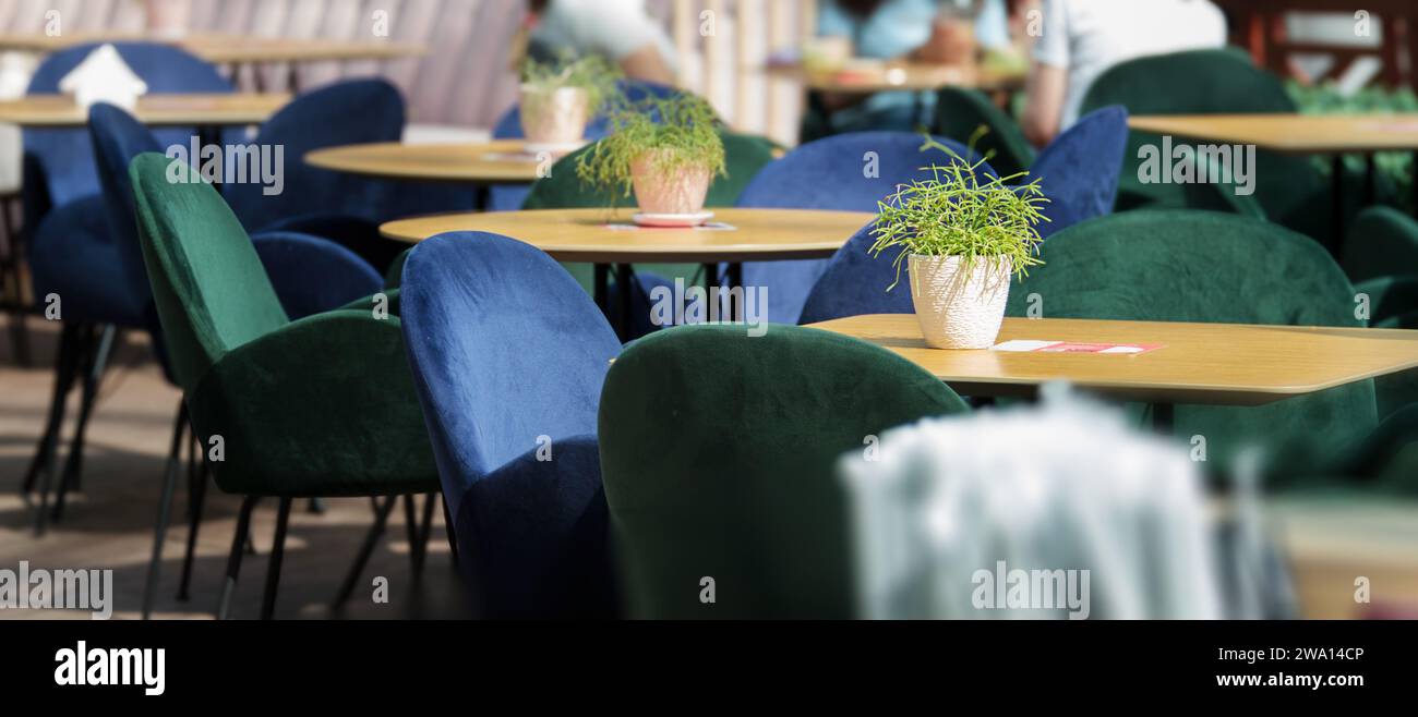 A background image of an empty interior with round tables and cozy chairs in a shopping center, copy space, abstract coffee shop cafe and restaurant f Stock Photo