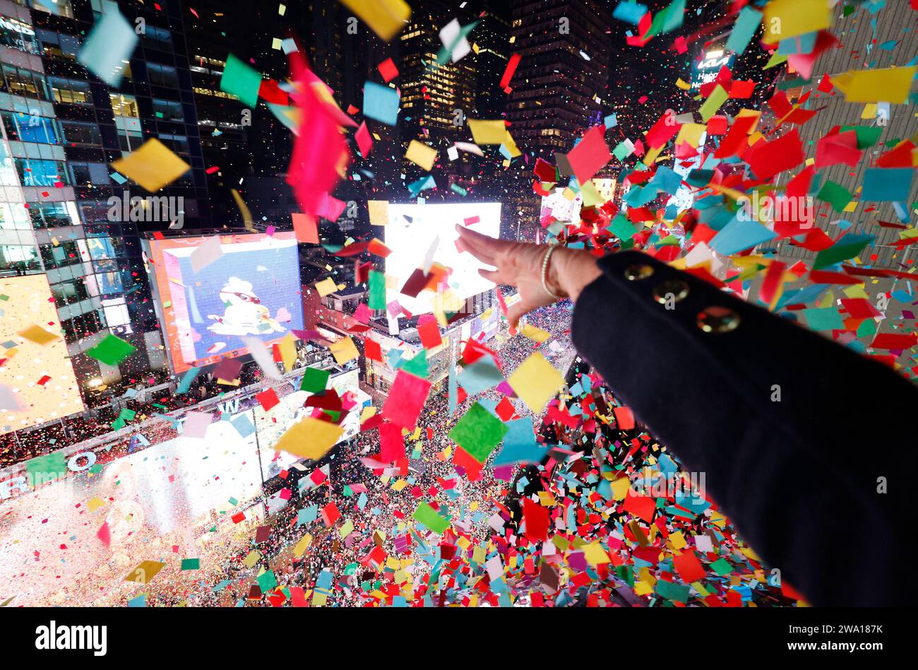 New York, United States. 01st Jan, 2024. A worker releases confetti at midnight in Times Square