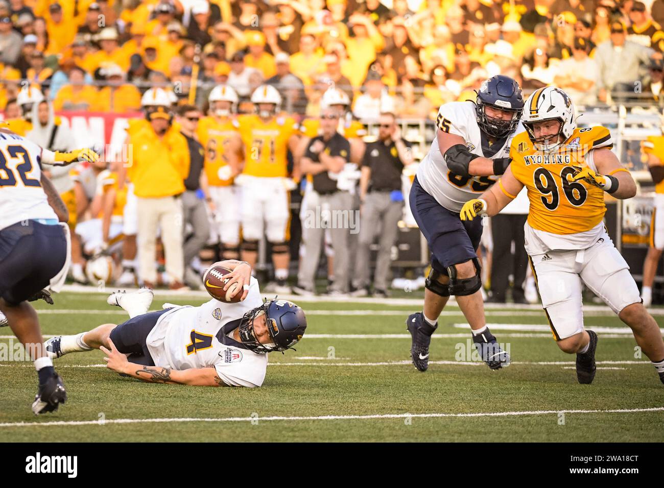 Toledo Rockets quarterback Tucker Gleason (4) reaches for a first down in the third quarter of an NCAA college football game against the Wyoming Cowbo Stock Photo