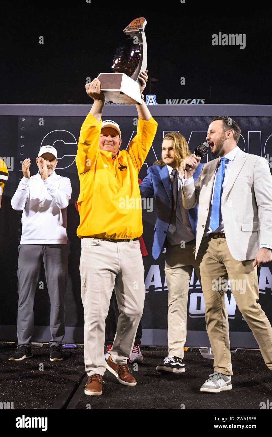 Wyoming Cowboys head coach Craig Bohl holds up the trophy in his final game after an NCAA college football game against the Toledo Rockets in Tucson, Stock Photo