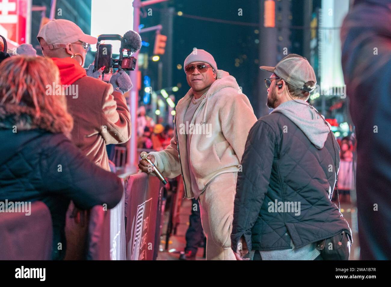 Rapper LL Cool J, center, stretches before his performance at the New ...