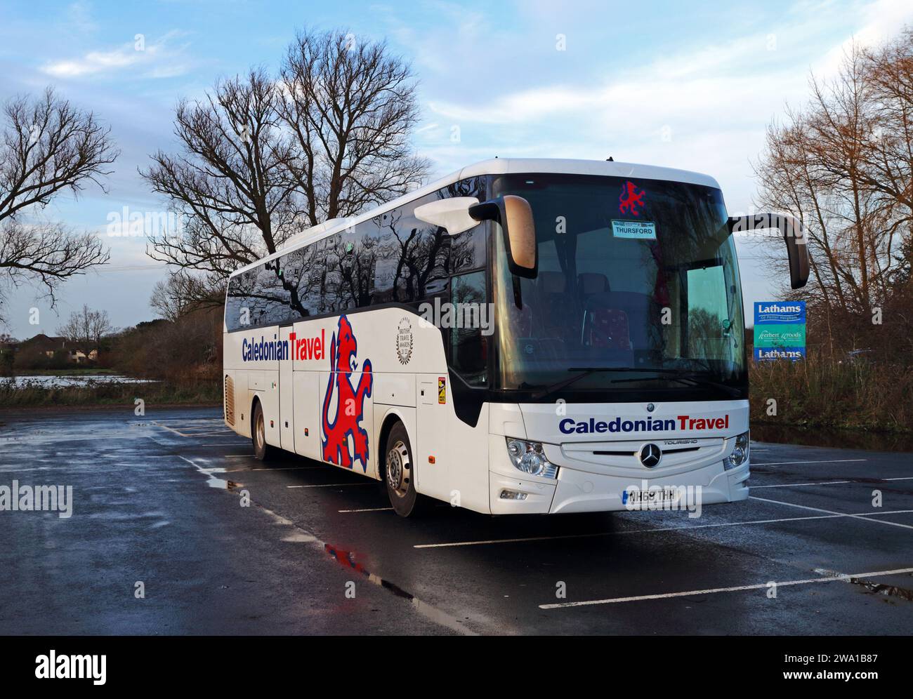 A Caledonian Travel coach parked at the popular Lathams store in the Norfolk Broads at Potter Heigham, Norfolk, England, United Kingdom. Stock Photo