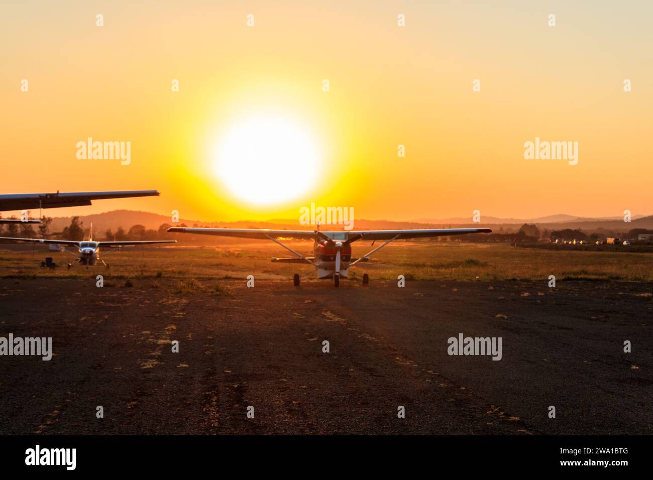 Small propeller airplanes at sunset in Arusha airport, Tanzania Stock Photo