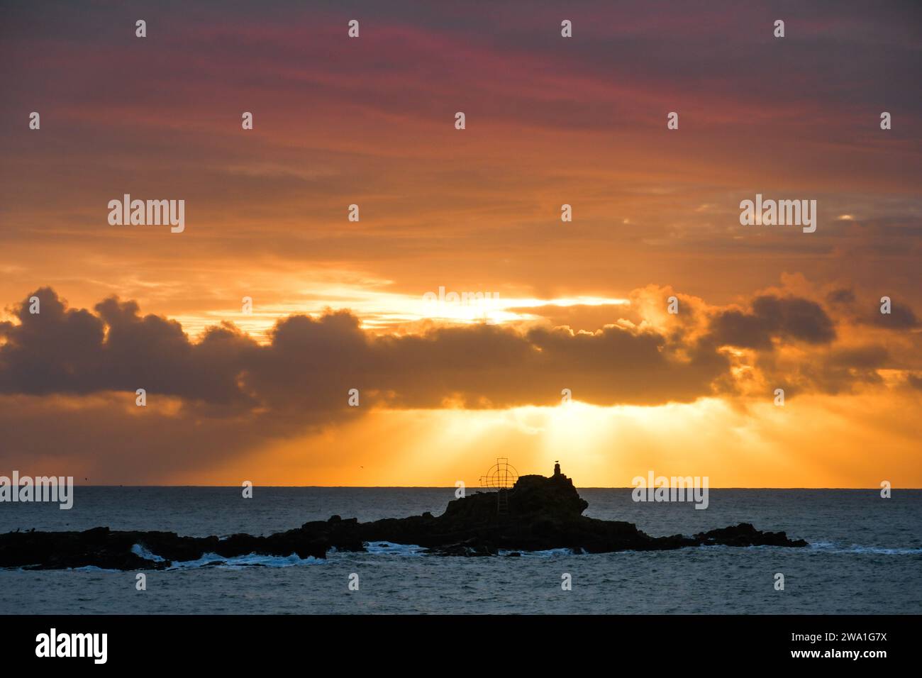 Mousehole Cornwall, UK. 1st January 2024. The first sunrise of the new year of 2024 was a colourful affair over St Clements Isle just off Mousehole this morning. Credit Simon Maycock / Alamy Live News. Stock Photo