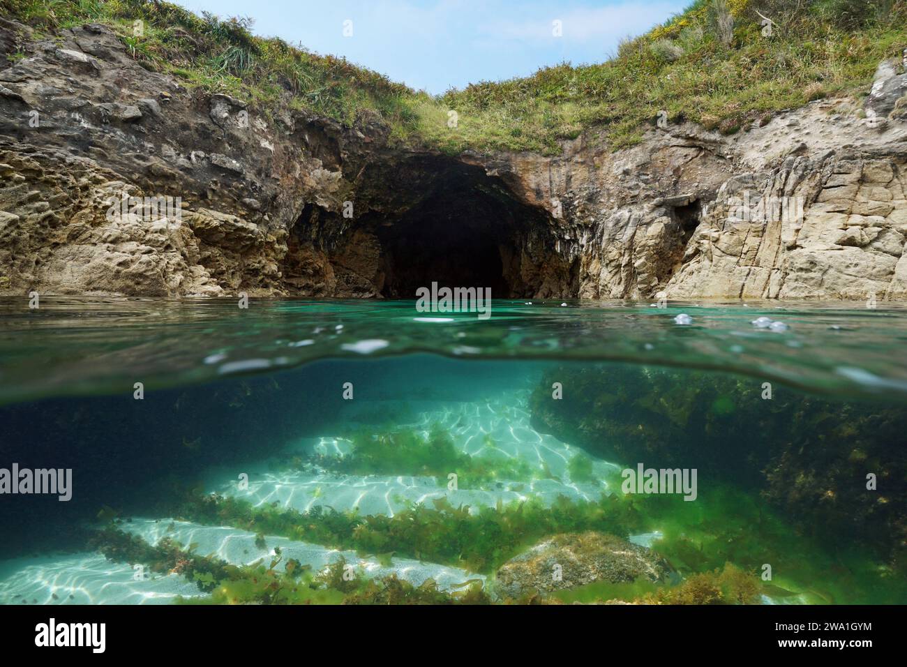 Sea cave on the Atlantic coastline, split level view over and under water surface, natural scene, Spain, Galicia, Rias Baixas Stock Photo