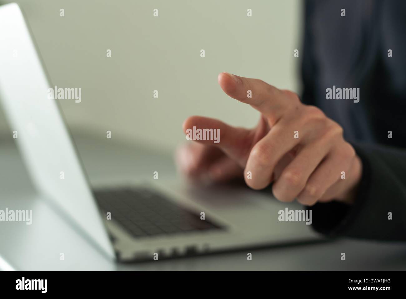 Finger pointing to laptop screen with important technology news ...