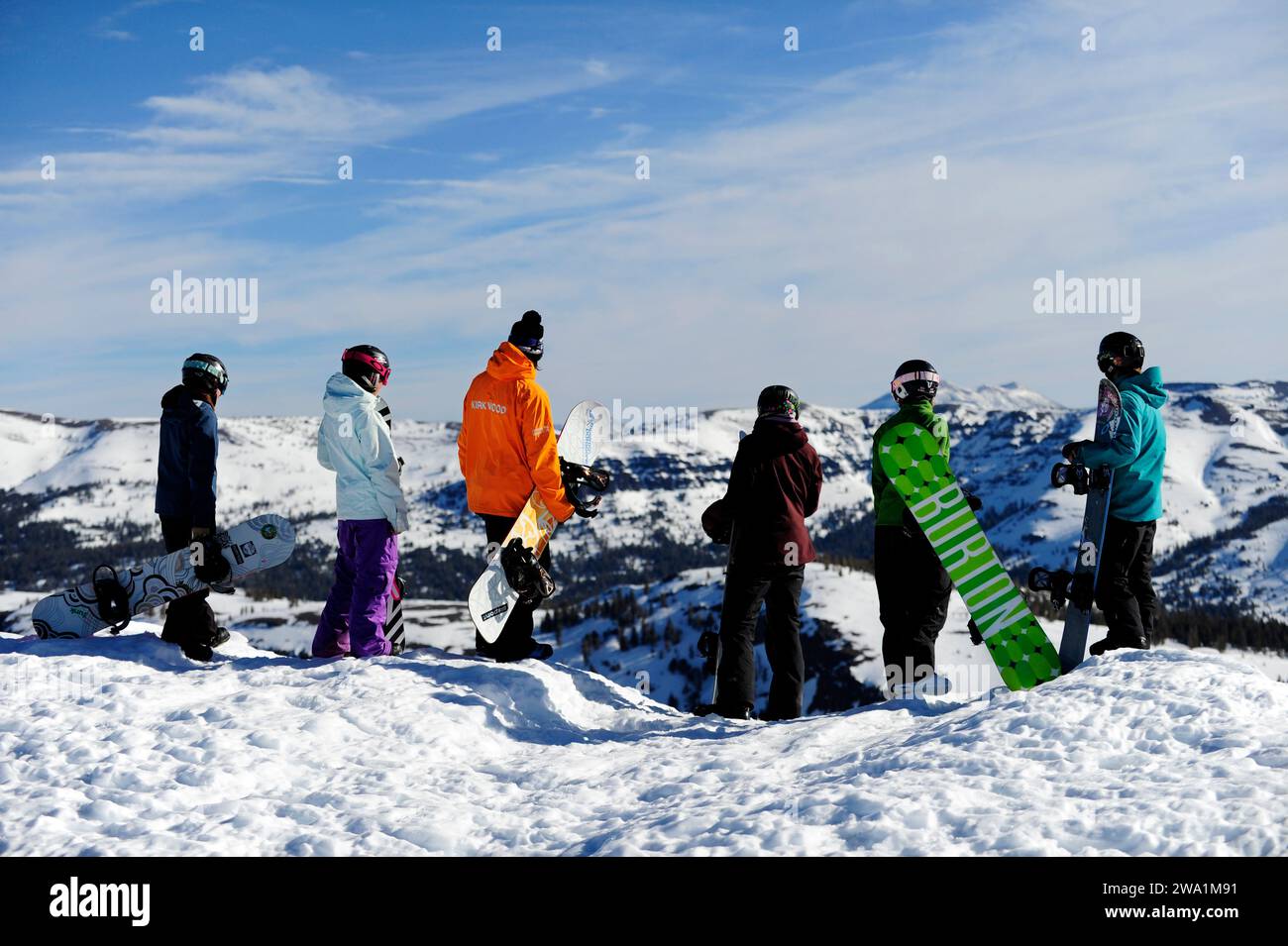 A group of snowboarders stand on a ridge with their instructor at a mountain resort near South Lake Tahoe, California. Stock Photo
