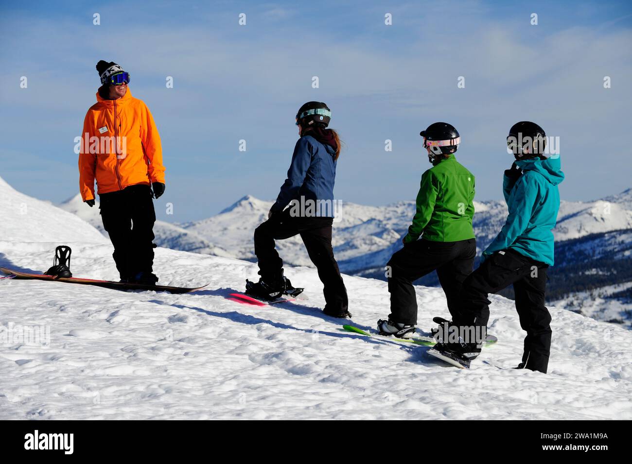 A snowboard instructor speaks to his students at a mountain resort near South Lake Tahoe, California. Stock Photo