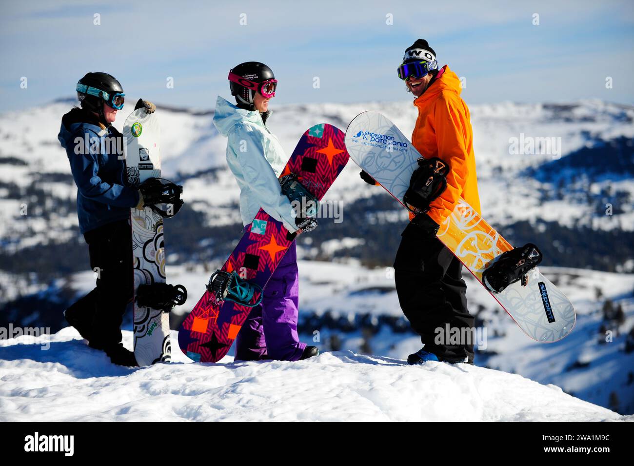 A group of snowboarders stand on a ridge with their instructor at a mountain resort near South Lake Tahoe, California. Stock Photo