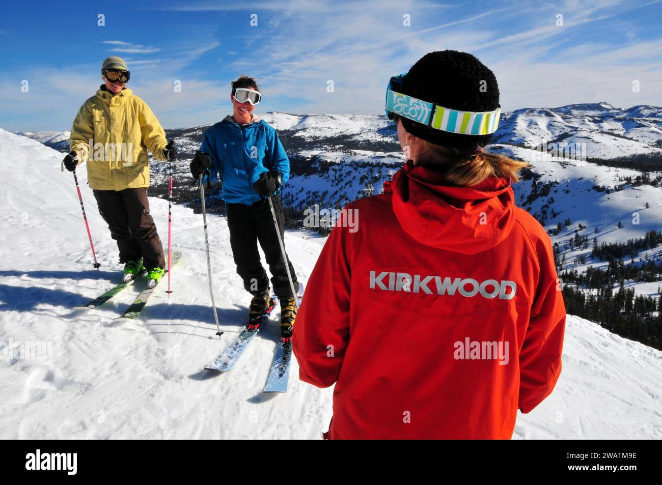 Two women take direction from their ski instructor at a mountain resort near South Lake Tahoe, California. Stock Photo