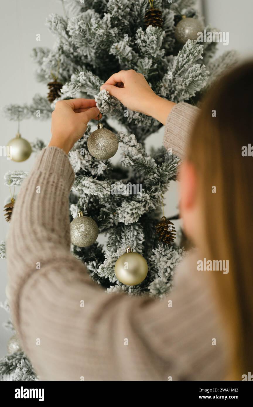 Woman decorating tree rear view hi-res stock photography and images - Alamy