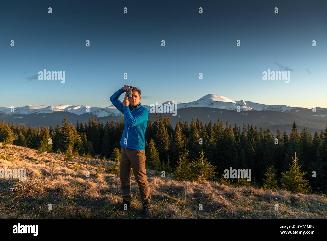Young Man Photographing a Beautiful View at Sunset Stock Photo