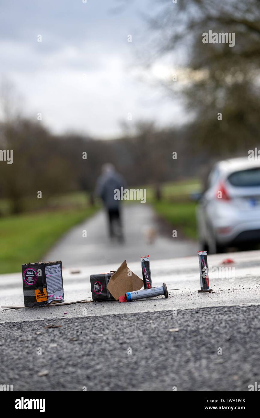 Gleusdorf, Germany. 01st Jan, 2024. The remains of burnt firefighters' bodies stand on the wet pavement of a road in Gleusdorf, Lower Franconia (Haßberge district), while a man walks his dog on New Year's morning. Credit: Pia Bayer/dpa/Alamy Live News Stock Photo