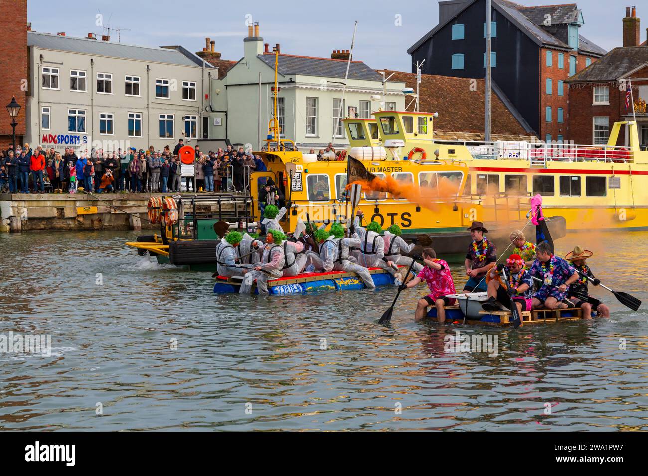 Poole, Dorset, UK. 1st January, 2024. The New Years Day Bath Tub Race takes place with plenty of thrill, spills and sabotage! Thousands turn out to watch the event, as a variety of unusual home made crafts take to the water to race, with participants having fun, throwing eggs and flour and capsizing competing craft. A feel good start to the New Year. Credit: Carolyn Jenkins/Alamy Live News Stock Photo