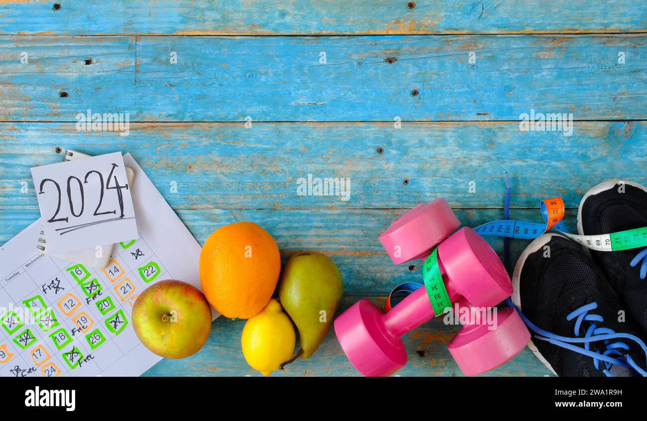 Resolutions for the New Year 2024, more sports,healthy eating,reducing weight, better work life balance. Flat lay with free copy space. Stock Photo