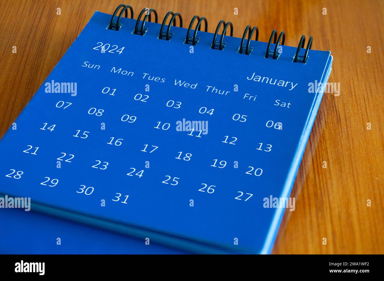 January 2024 table calendar on wooden desk. Time and calendar concept ...
