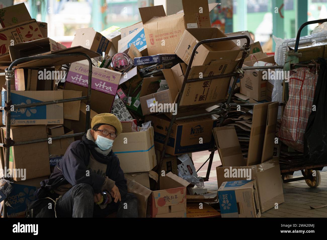A man collects cardboard on a street in Hong Kong Stock Photo