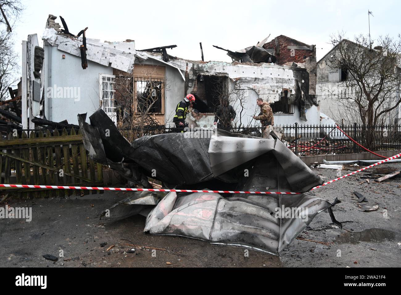 Lviv, Ukraine January 1, 2024 Ukrainian firefighters inspect the destroyed building Roman