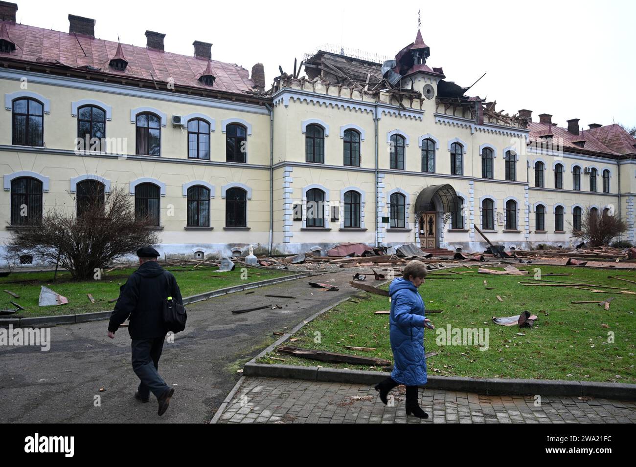 Lviv, Ukraine - January 1, 2024: People outside the damaged Lviv National University of Nature Management, after a Russian drone attack in Lviv. Stock Photo