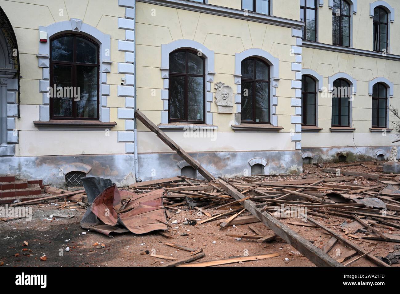 Lviv, Ukraine - January 1, 2024: People outside the damaged Lviv National University of Nature Management, after a Russian drone attack in Lviv. Stock Photo