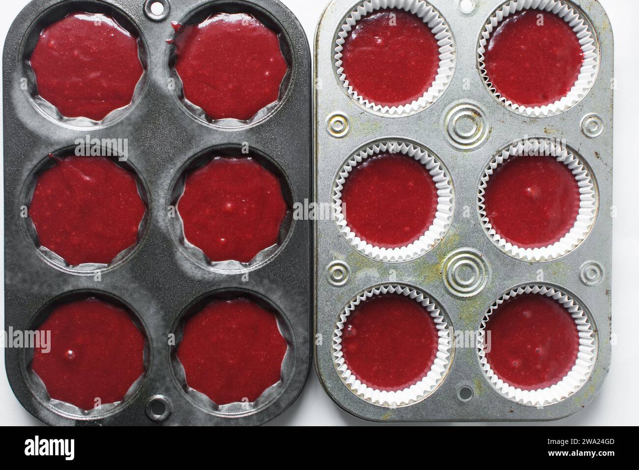 Top view of Red velvet cupcake batter in a muffin tin, scooped red velvet cake batter, process of making valentines cupcakes Stock Photo
