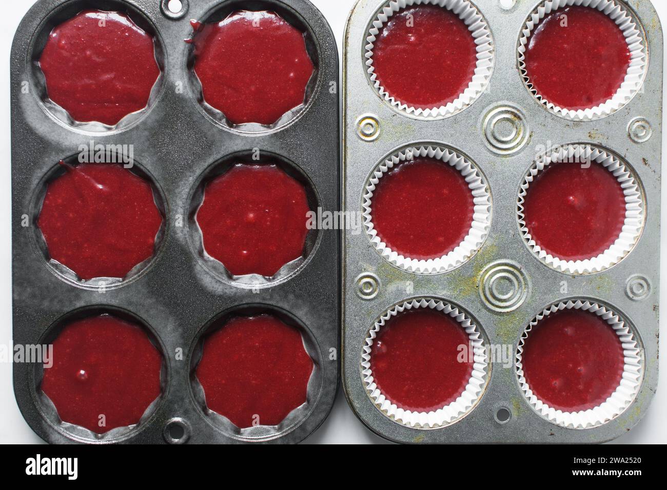 Top view of Red velvet cupcake batter in a muffin tin, scooped red velvet cake batter, process of making valentines cupcakes Stock Photo