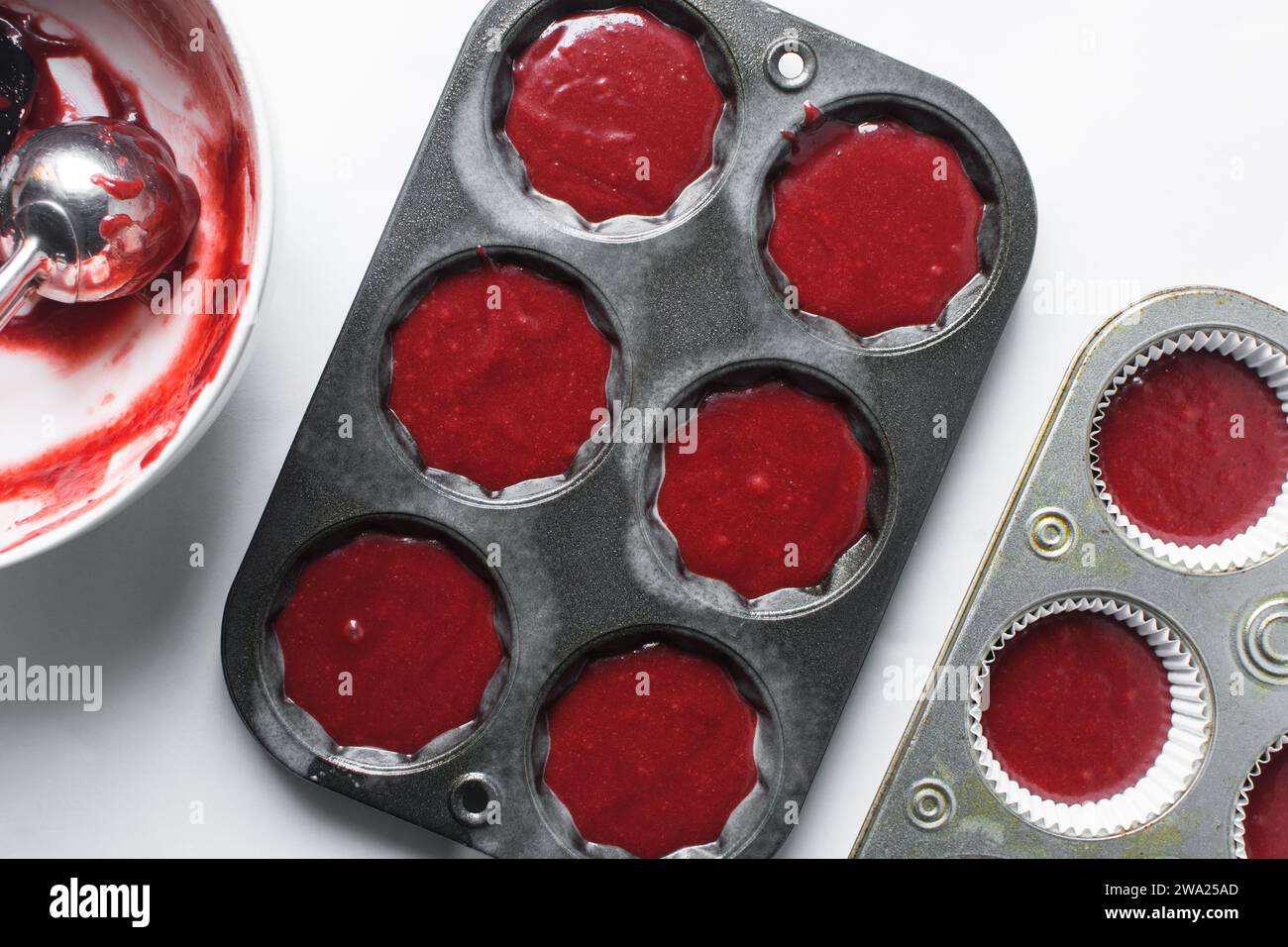 Top view of Red velvet cupcake batter in a muffin tin, scooped red velvet cake batter, process of making valentines cupcakes Stock Photo