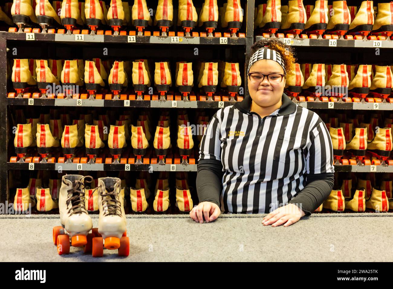 A female employee stands at the service counter ready to provide rental