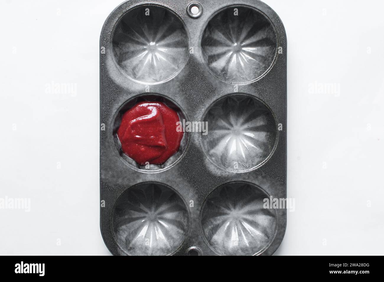Top view of Red velvet cupcake batter in a muffin tin, scooped red velvet cake batter, process of making valentines cupcakes Stock Photo