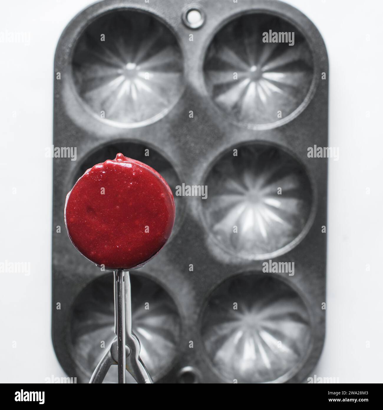 Top view of Red velvet cupcake batter in a silver scoop, scooped red velvet cake batter, process of making valentines cupcakes Stock Photo