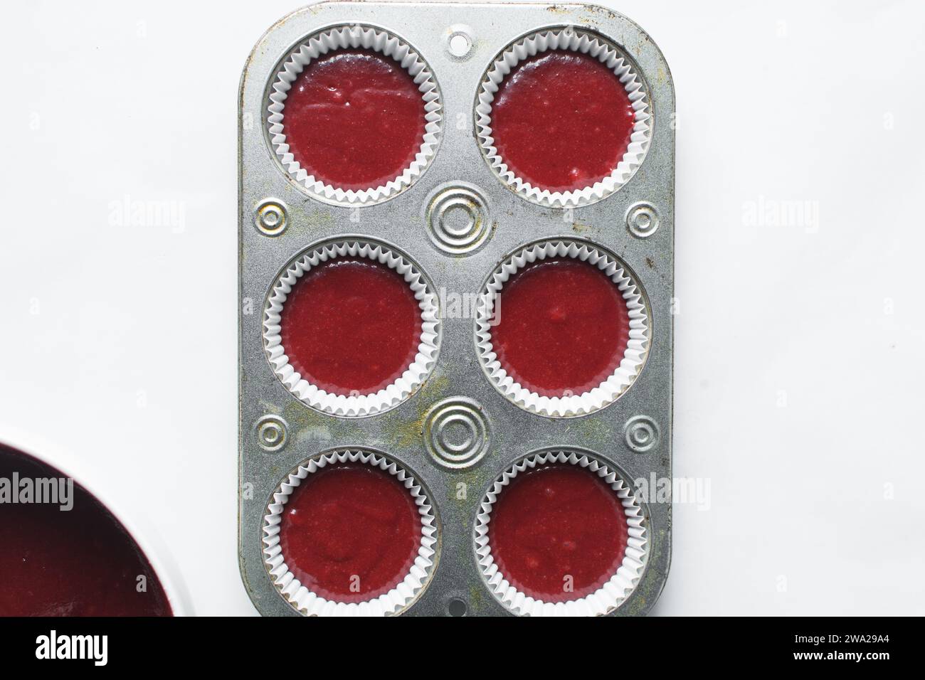 Top view of Red velvet cupcake batter in a muffin tin, scooped red velvet cake batter, process of making valentines cupcakes Stock Photo