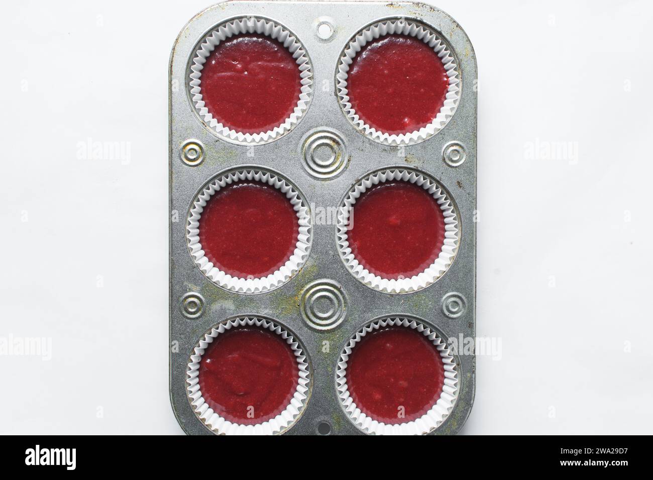 Top view of Red velvet cupcake batter in a muffin tin, scooped red velvet cake batter, process of making valentines cupcakes Stock Photo