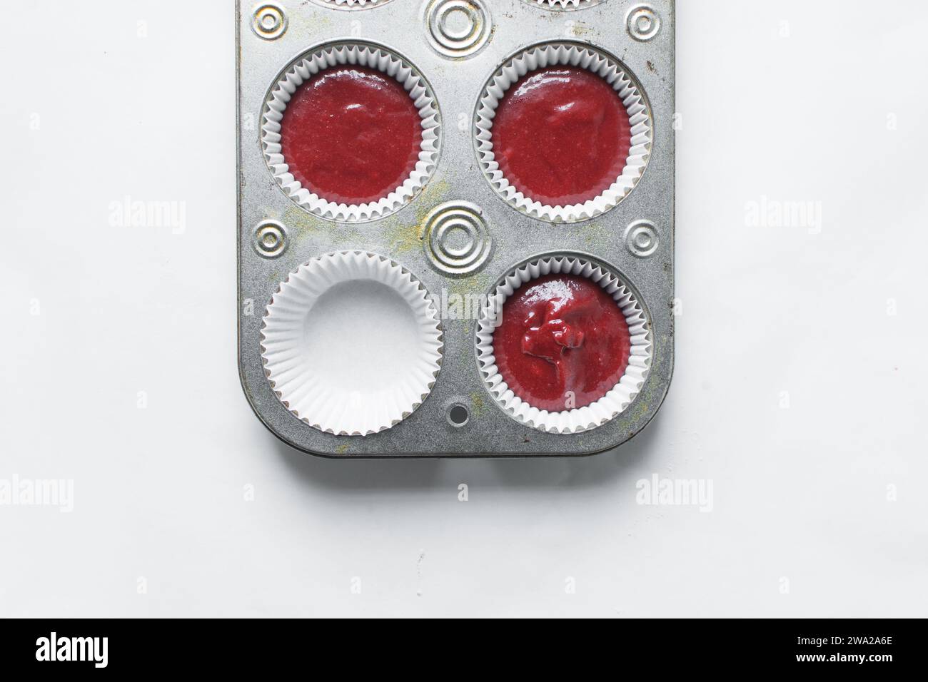Top view of Red velvet cupcake batter in a muffin tin, scooped red velvet cake batter, process of making valentines cupcakes Stock Photo