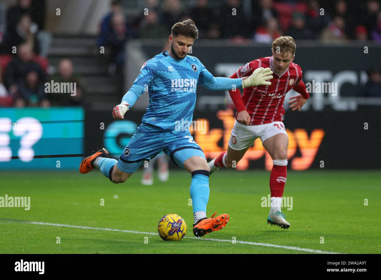 Millwall goalkeeper Matija Sarkic (left) and Ipswich Town's Cameron Burgess battle for the ball during the Sky Bet Championship match at Ashton Gate, Bristol. Picture date: Monday January 1, 2024. Stock Photo