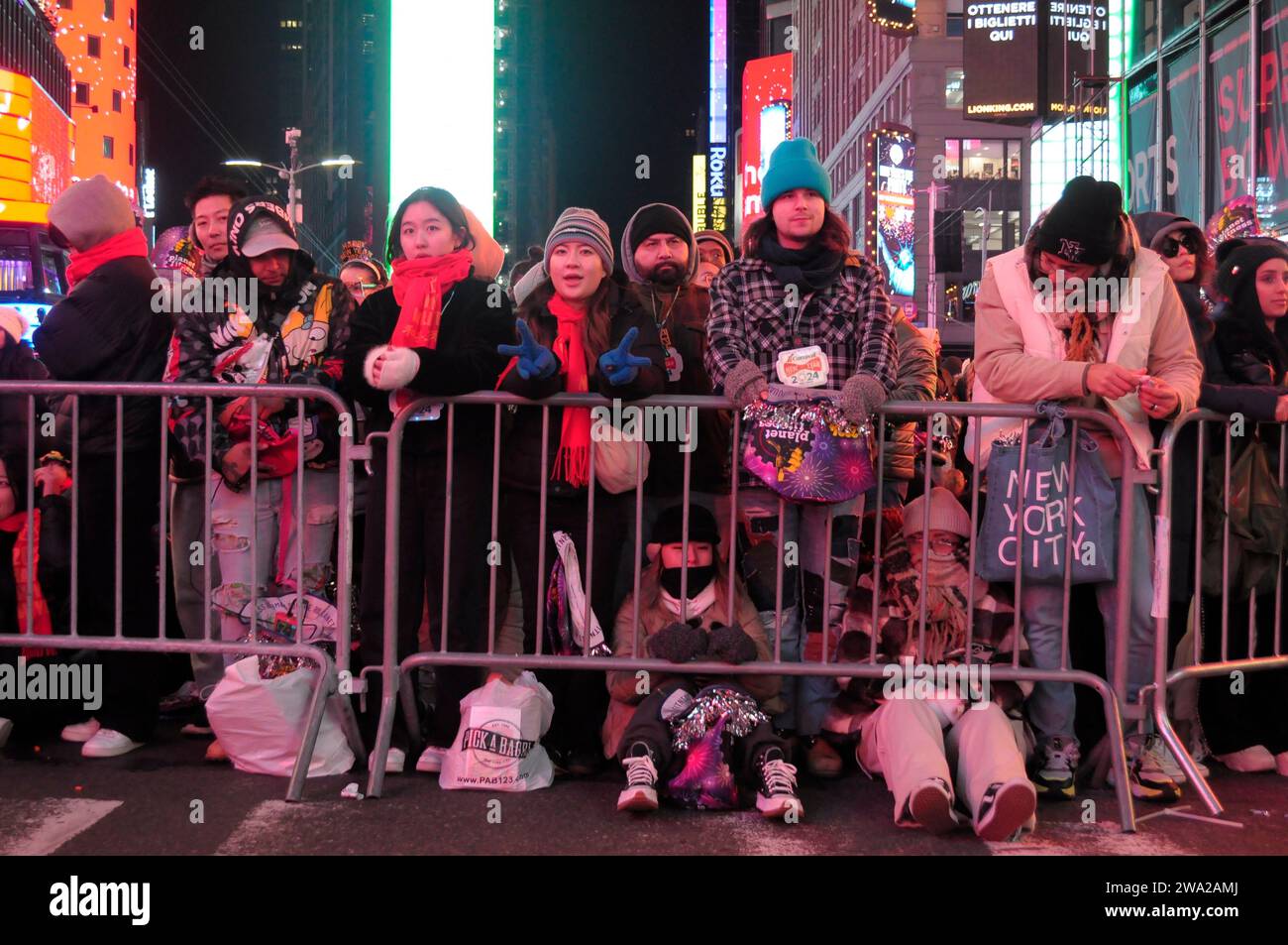 New York, United States. 31st Dec, 2023. A crowd of revelers, some