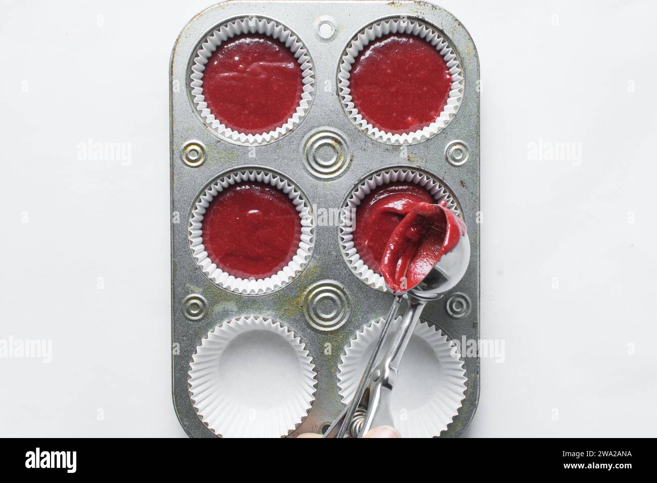 Top view of Red velvet cupcake batter in a muffin tin, scooped red velvet cake batter, process of making valentines cupcakes Stock Photo