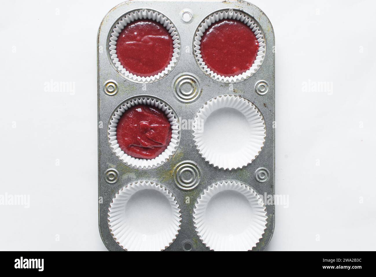 Top view of Red velvet cupcake batter in a muffin tin, scooped red velvet cake batter, process of making valentines cupcakes Stock Photo