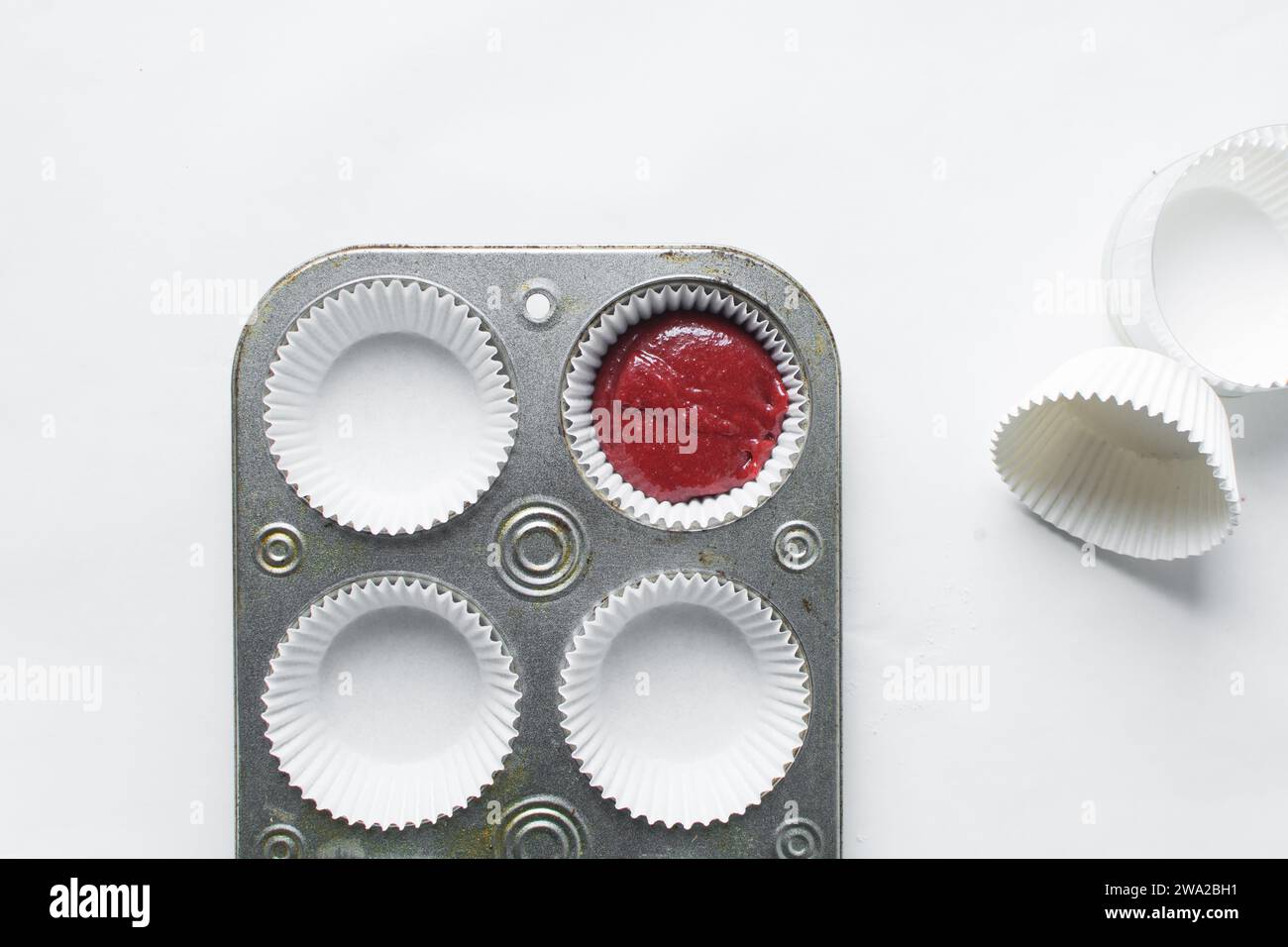 Top view of Red velvet cupcake batter in a muffin tin, scooped red velvet cake batter, process of making valentines cupcakes Stock Photo