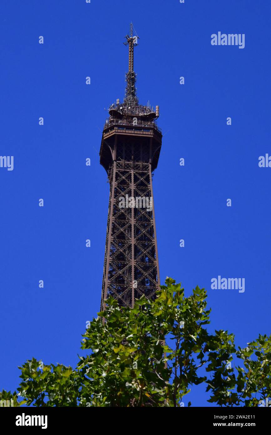 Top of the Eiffel Tower against a blue sky. Stock Photo