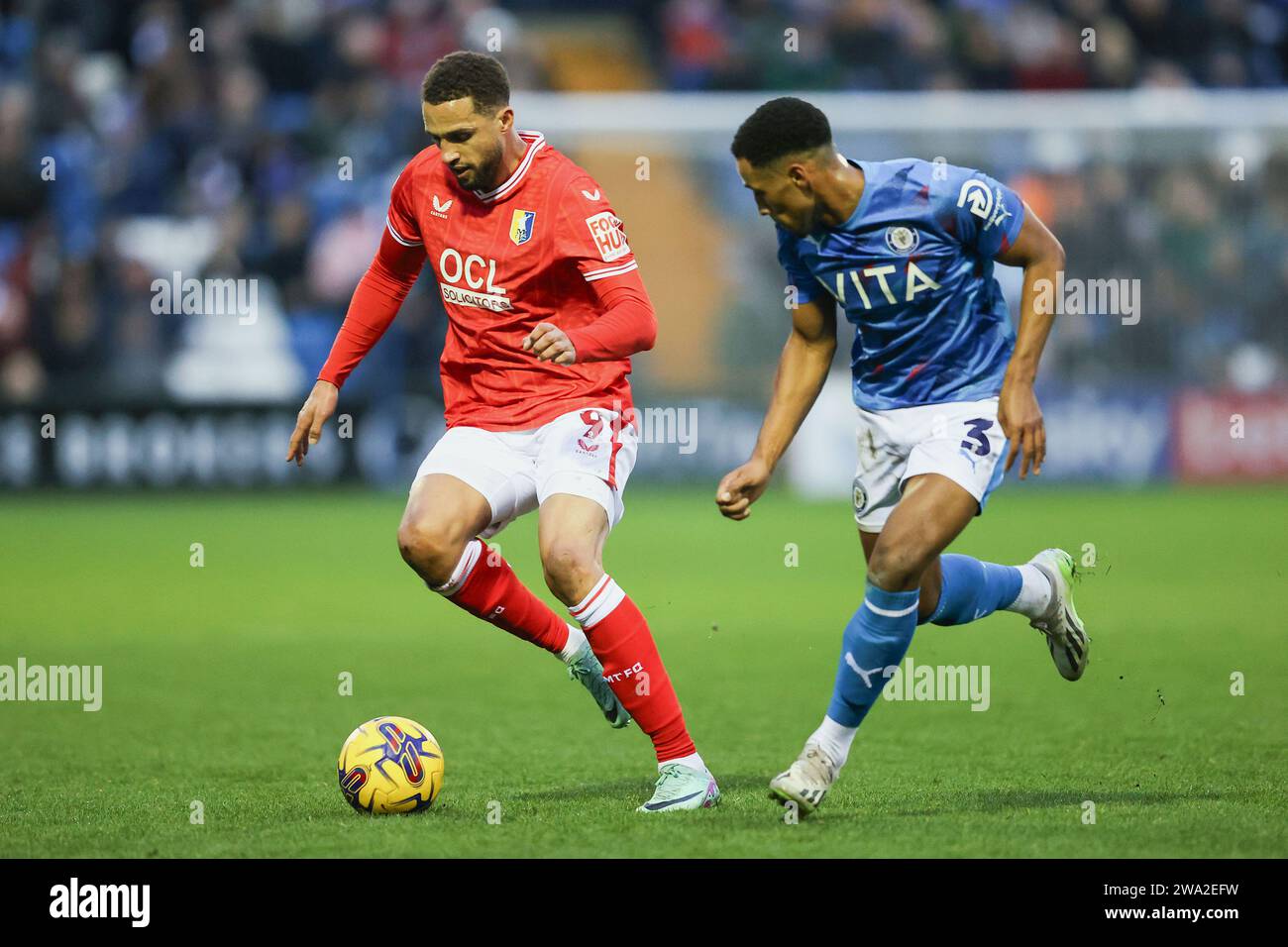 Stockport on Monday 1st January 2024. Mansfield's Jordan Bowery holds