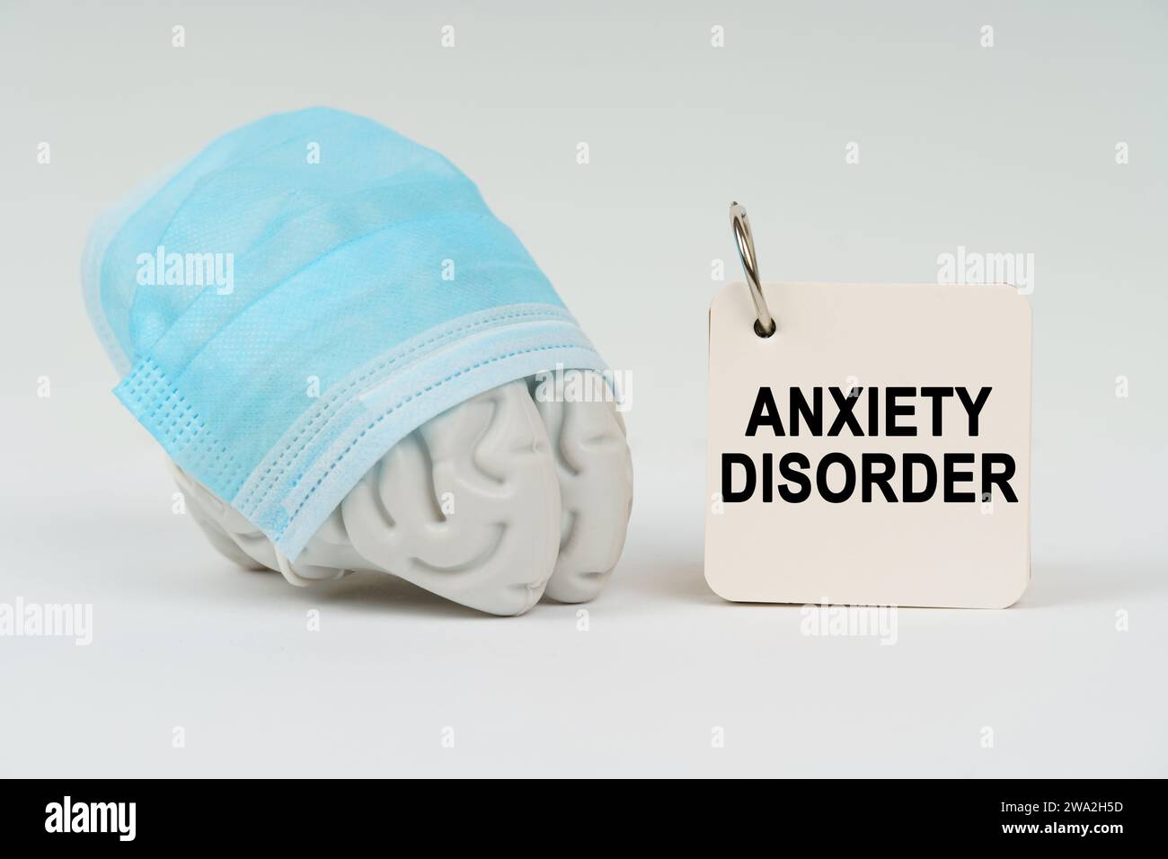 Medical concept. On a white surface next to the brain there is a notepad with the inscription - Anxiety disorder Stock Photo
