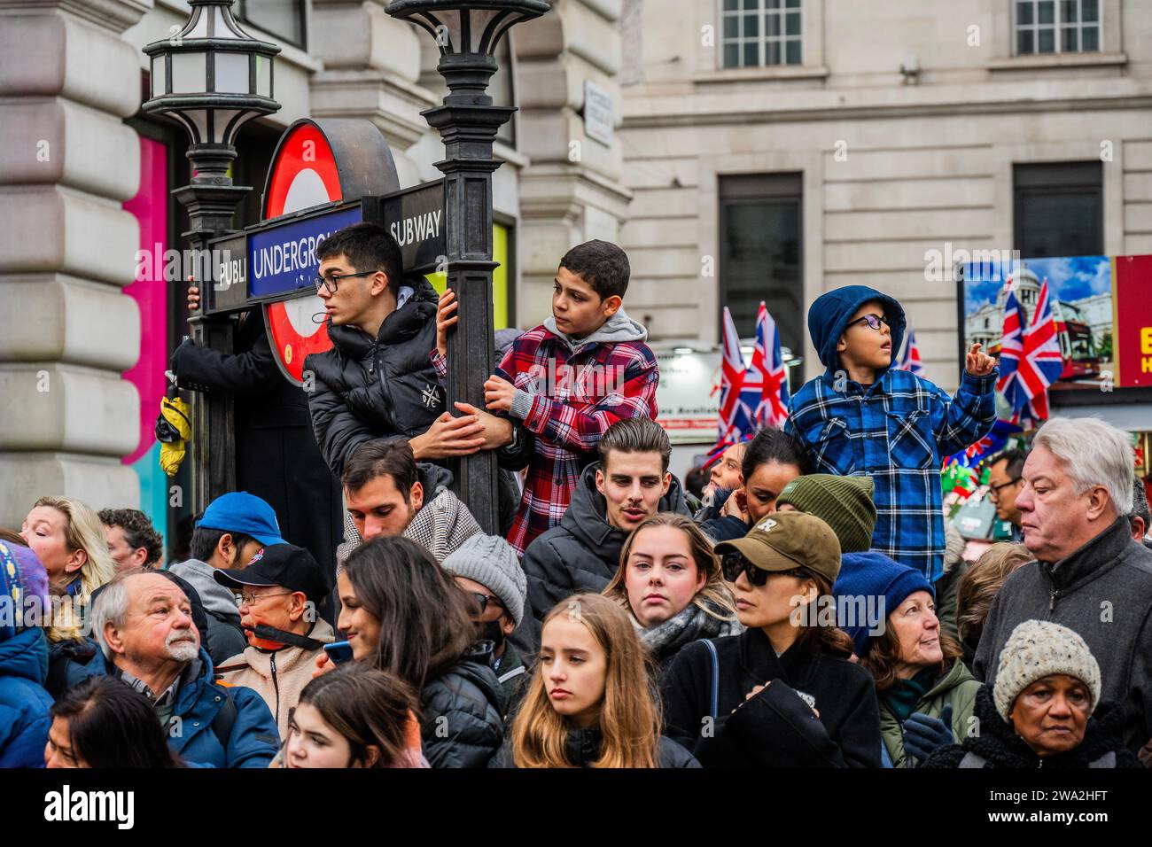 London, UK. 1st Jan, 2024. Crowds use all vantage points- The London