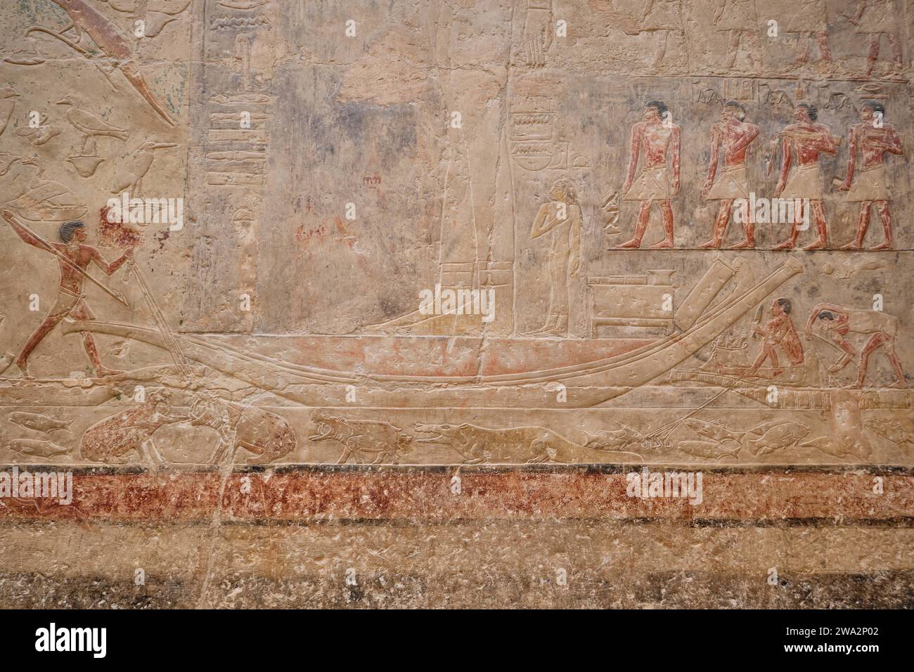 Saqqara, Egypt - January 2, 2024: Painted bas relief figures showing daily life in ancient Egypt inside a mastaba tomb in Saqqara necropolis Stock Photo