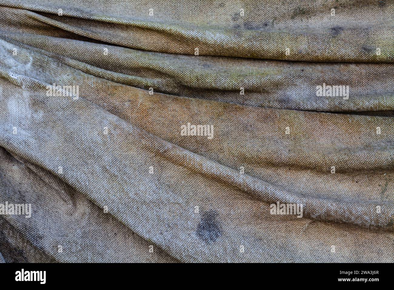 Abstract image of a weathered canvas sheet covering some stored equipment Stock Photo