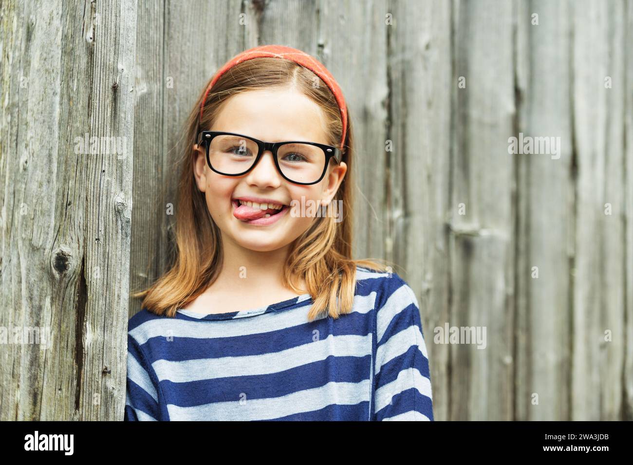 Outdoor portrait of a cute little 9 year old girl wearing eyeglasses Stock Photo