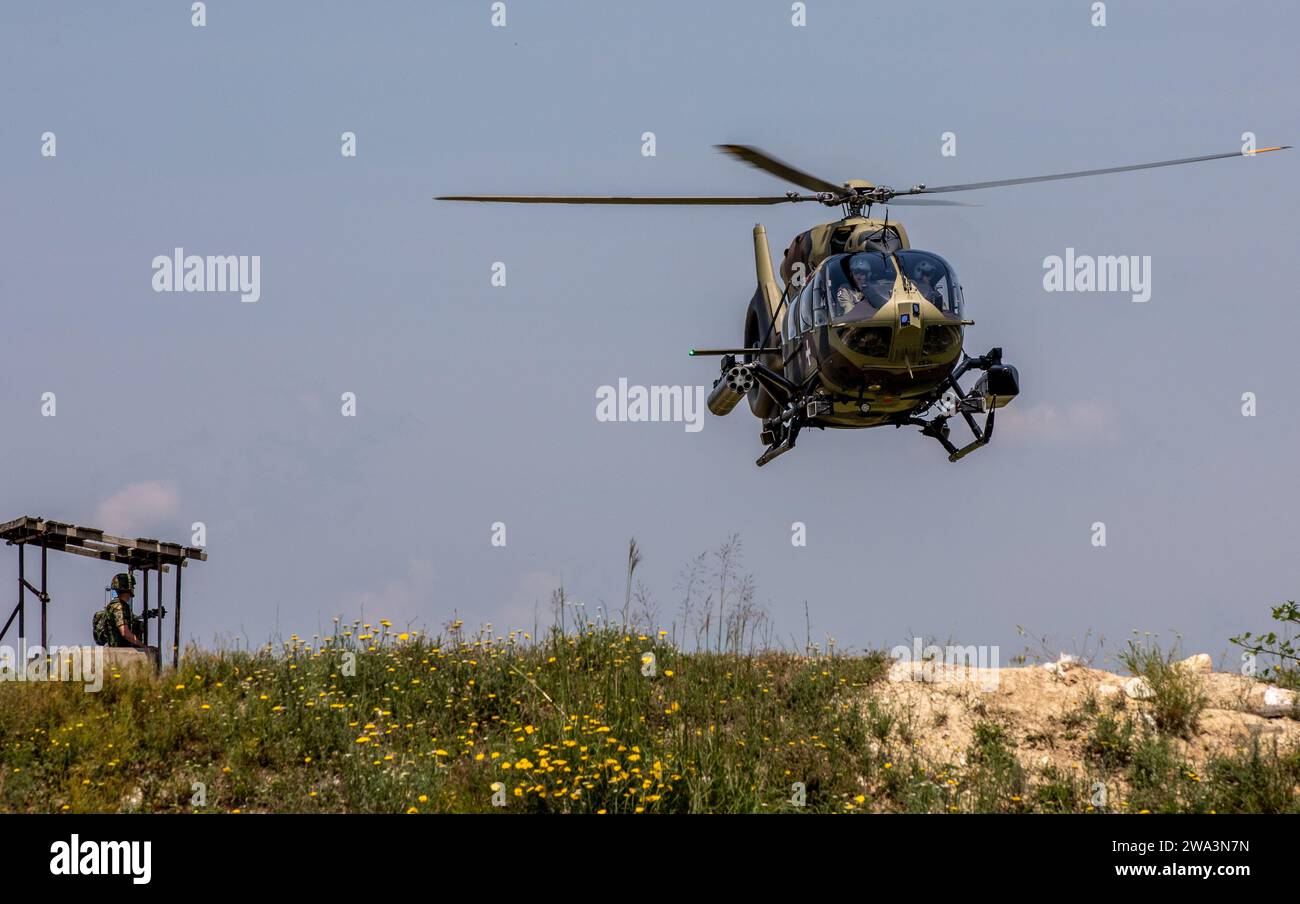 An HH-60 Pave Hawk helicopter with Task Force Brawlers, 3rd Combat Aviation Brigade, 3rd Infantry Division, hovers above a landing zone during Platinum Wolf 2023 at South Base, Serbia, June 22, 2023. First conducted in 2014, Platinum Wolf focuses on nonlethal systems training and peacetime operations to foster greater interoperability while promoting peace and prosperity in the Black Sea, Balkan and Caucasus regions. (U.S. Army National Guard photo by Spc. Michael Baumberger, 196th Mobile Public Affairs Detachment) Stock Photo